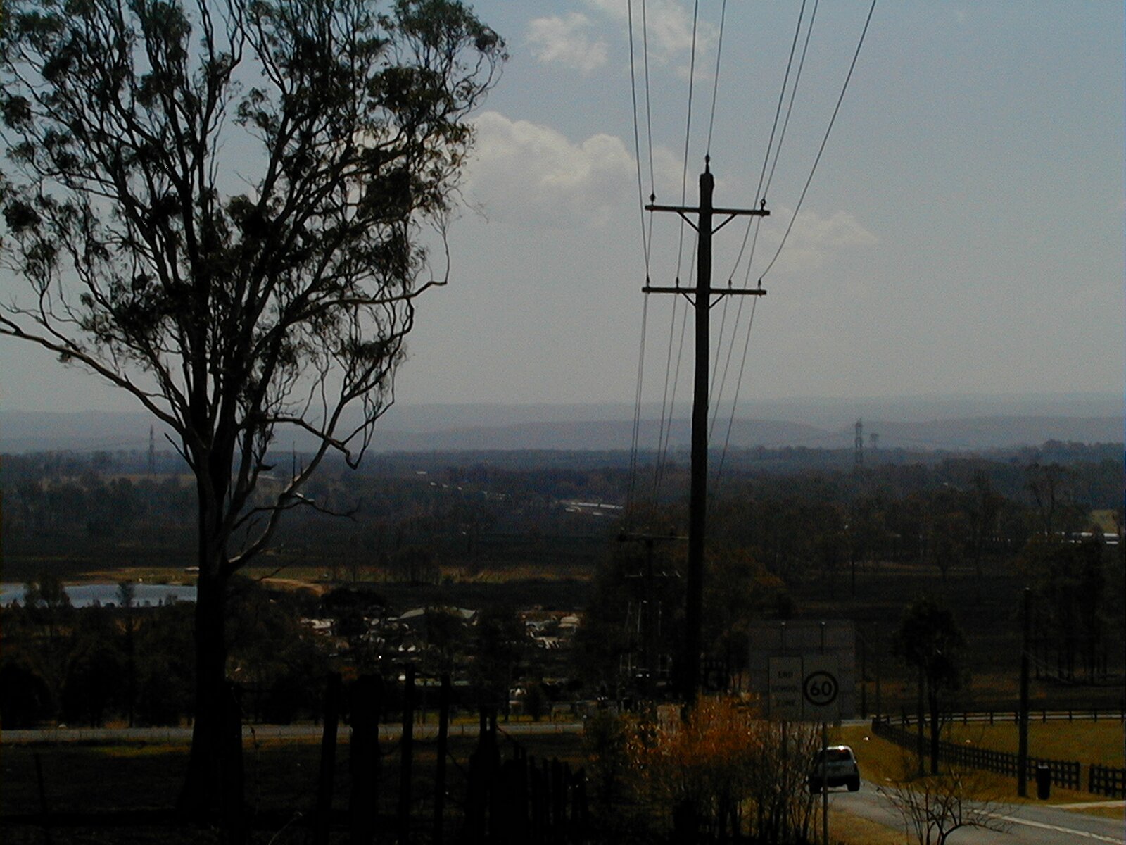 Thick smoke haze hanging over houses and paddocks on the valley floor